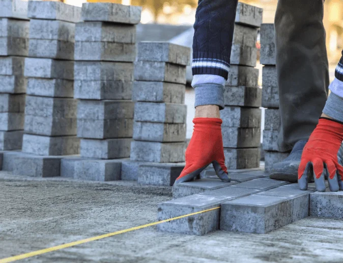 installing-paving-construction-stone-block-sidewalk-road-working-interlock-construction-site
