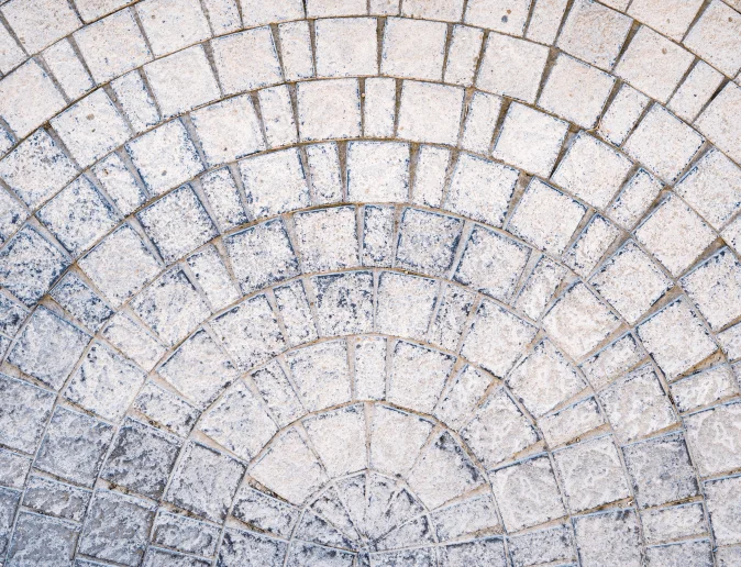 arched-cobblestone-pavement-road-with-edge-courses-sidewalk-texture